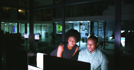 Night, meeting and business people on computer in office for finance review, budget planning and...