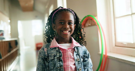 Black child, portrait and happy in hallway for education, learning opportunity or back to school....