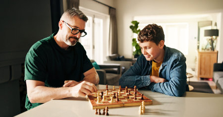 Playing, bonding and father with child for chess in home for learning, development or competition....