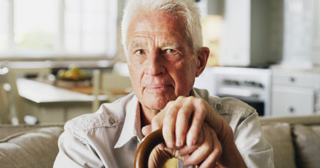 Serious, walking stick and portrait of senior man in home with relax, peace and medical support....