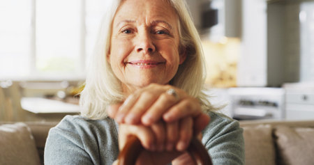 Happy, walking stick and portrait of senior woman in home with relax, peace and medical support....