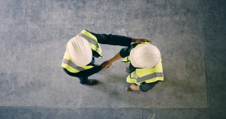 Top view, engineer and people with handshake for construction deal, agreement or space. Above,...