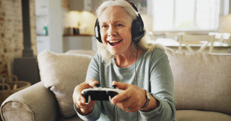 Senior, happy woman and playing with video games on sofa for fun online entertainment in home....