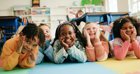Classroom, happy kids and students on floor for education, diversity or elementary school. Children,...