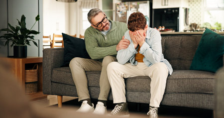 Comfort, consoling and crying son with father on sofa in living room of home for empathy or support....