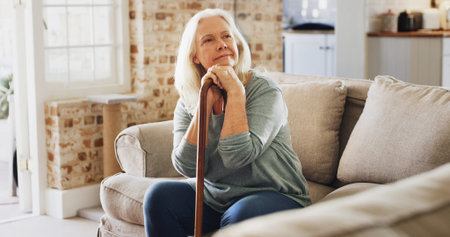Thinking, relax and old woman in home with walking stick, pensioner and calm in living room. Peace,...