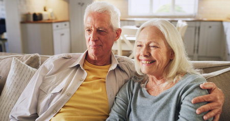 Senior couple, happy or watching TV on sofa with bonding together, entertainment or streaming film....