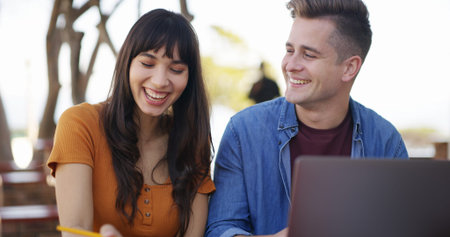 Laptop, laugh and students at university with studying for test, assignment or exam together....