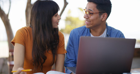 Laptop, textbook and students at university with studying for test, assignment or exam together....