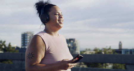 Music, fitness and woman with mobile in city for streaming sound, podcast to listen to radio....