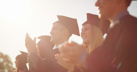 Outdoor, applause and students with celebration, graduation and achievement with success. People,...