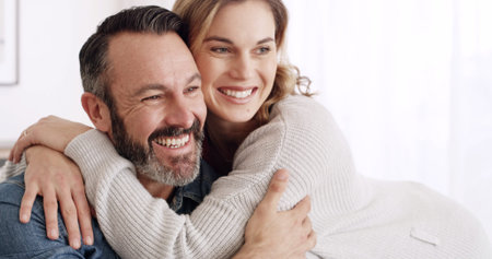 Happy, hug and mature couple in home with love, bonding or connection in marriage together. Smile,...