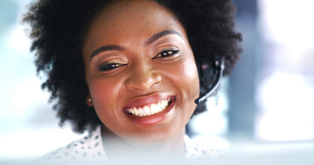 Happy, black woman and agent laughing with headset for online advice or communication in office....