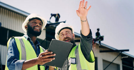 Men, engineer and tablet with advice at construction site for review, inspection and progress...