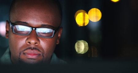 Business, black man and computer in office at night for trading news, market trends or bokeh....