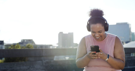 Headphones, fitness and happy woman with mobile in city for audio, space or motivation playlist....