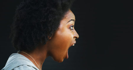 Angry, scream and profile of black woman with shout, yelling or frustrated in studio. Crisis, stress...
