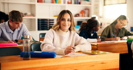Portrait, high school and girl in classroom, students and writing tests with education. Teenagers,...