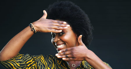 Portrait, black woman and frame of hands in studio with smile for profile picture on grey...