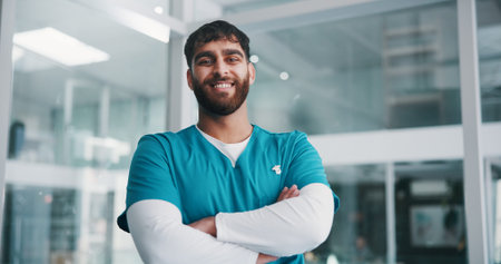Arms crossed, nurse and portrait of man in hospital for healthcare consultant, smile and confidence....