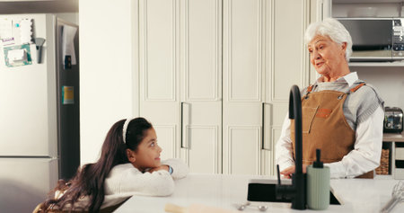Home, grandmother and girl in kitchen, conversation and bonding together with happiness. Apartment,...
