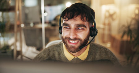 Call center, night and man with smile, tech and friendly service with headset, talking and help...