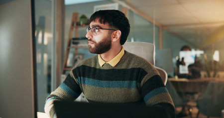 Serious, man and research on computer in office, deadline or financial analyst with project at...