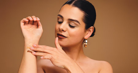 Woman, arm and foundation swatch for beauty with makeup, color choice or cosmetics in studio. Female person, show concealer or decision for contour, blending space and cosmetology on backgroundの写真素材