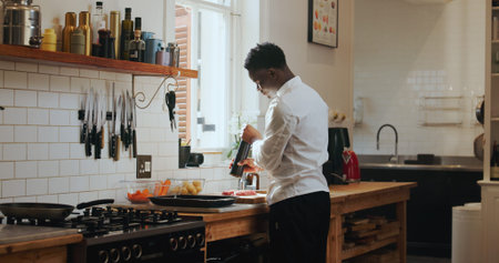 Cooking, spice and steak with black man in kitchen of home for meal preparation or recipe. Culinary...