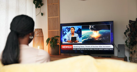 Breaking news, nuclear war and woman watching tv on sofa for live report, global conflict or threat....