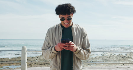 Sunglasses, promenade or man typing with phone, holiday adventure or internet post for travel...
