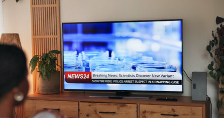 Watching, screen and person in home with headline, breaking news and healthcare alert in pandemic...