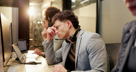 Man, stress and headache with computer at call centre for customer service, crm and client...