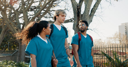 Medical student, group and walk at campus, talk and ready for education, class and outdoor at...