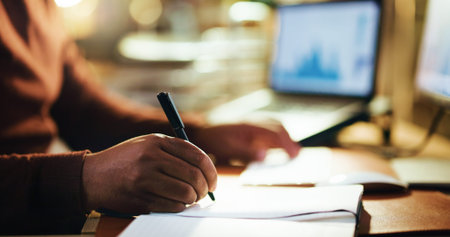 Writing, night and hand in office with closeup, business journal and technology in workplace....