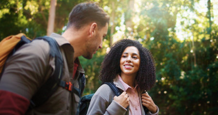Hiking, walking and smile with couple in nature for holiday, trekking adventure and bonding. Backpacking date, environment and vacation with man and woman in forest for love, support and hobbyの写真素材