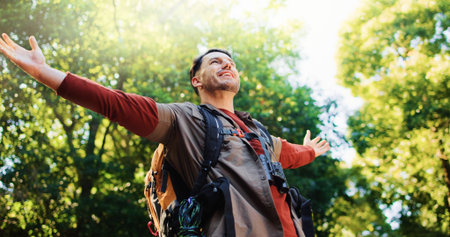 Happy man, freedom and hiking in forest with achievement, goals and stretching arms in nature....