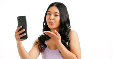 Woman, hair care and blow kiss for selfie in studio, salon review and social media engagement. Girl,...