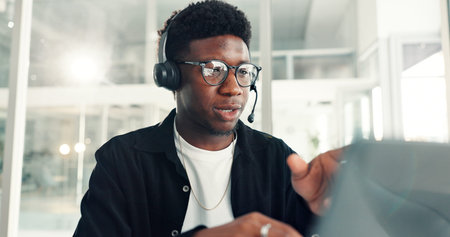 Customer service, call center and black man with headset in office for advice, online help and...