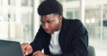 Business, online reading and black man with laptop, creative agency and email with manuscript....
