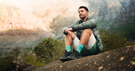 Calm, hiker and man on break in nature, breathing and mindfulness on vacation, fitness or adventure....