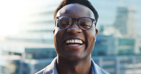 Laugh, outdoor and portrait of black man in city with confidence for corporate finance career. Glasses, professional and face of African male financial advisor from Colombia with pride in urban town.の写真素材