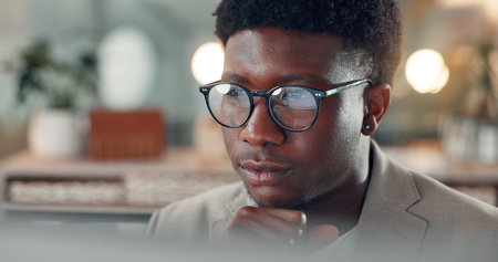 Business, thinking and black man with glasses, computer and online reading with creative agency....