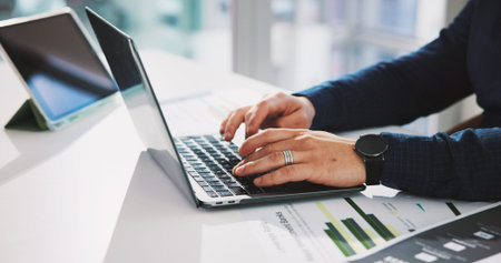 Hands, laptop and typing with business person at desk in office for financial report or review....