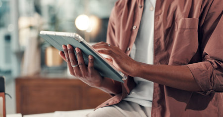 Hands, tablet and person with reading in office, scroll for research or info for marketing campaign. Bokeh, review or worker with tech to check online traffic, multimedia project or creative startupの写真素材