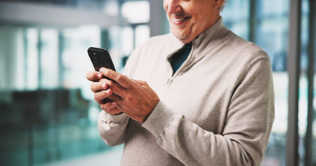 Typing, smile and mature man in office with phone, online networking or positive feedback on client....