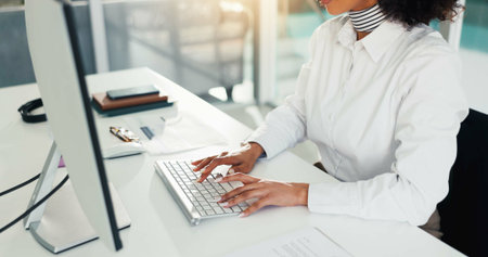 Hands, computer and businesswoman typing in office for report, email or compliance review. Keyboard,...