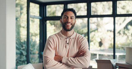 Portrait, smile and man in new home with arms crossed for moving, real estate property or ownership....