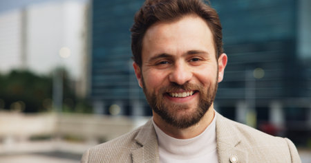 Property development, portrait and smile of business man dowtown for real estate investment or sale. Architecture, buildings and commercial infrastructure with happy developer person outdoor in cityの写真素材