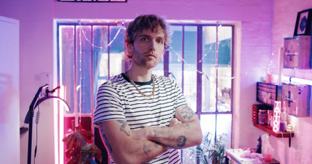 Portrait, neon and man in tattoo studio with arms crossed, design and startup owner of parlor....